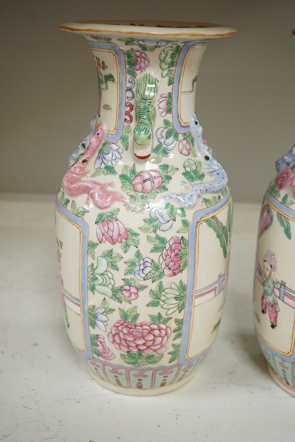 A pair of Chinese famille rose vases, 30cm high